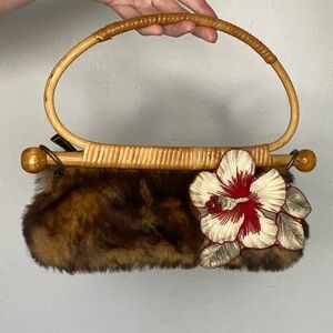 Unique brown faux fur purse with fabric hibiscus flower and rattan handle.